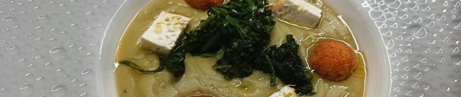 Macco di fava cottoia con cicoria ripassata in padella,ricotta ovina gratinata, polpettine di pane e brodo di finocchi all’arancia